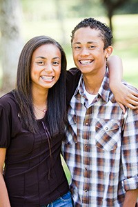 Two teenagers smiling.